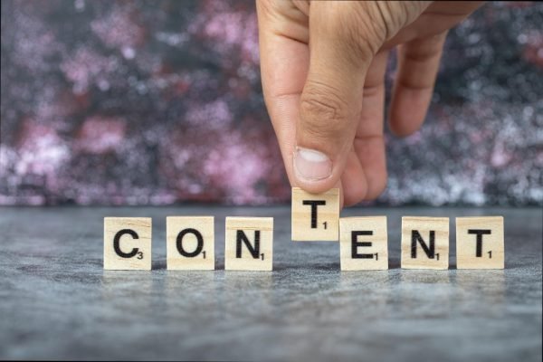 content-writing-with-black-letters-wooden-dices-blue-background-high-quality-photo (1)