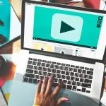 hand-typing-laptop-with-play-button-screen (1)