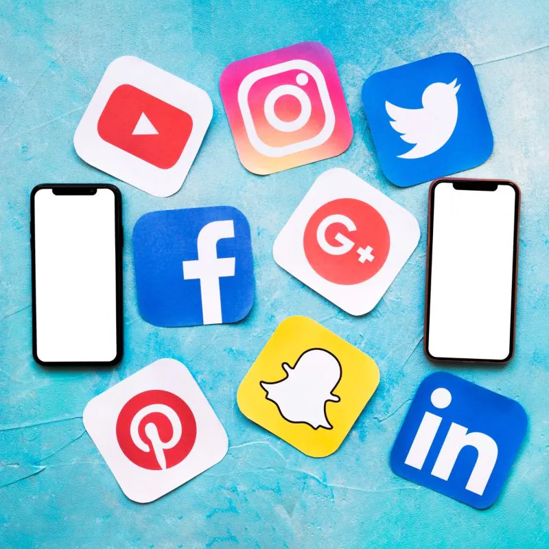 social-media-icons-with-two-blank-cellphone-blue-painted-wall (1)